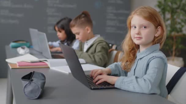 Slowmo Portrait Elementary Age Caucasian Girl Sitting Desk Classroom Front — Stock Video