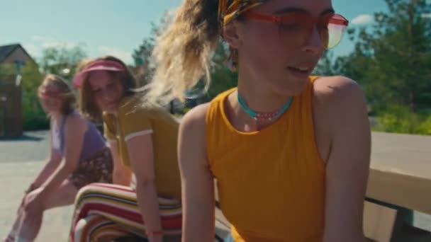 Three Caucasian Girls Sitting Bench Park Summer Day One Them — Stock Video