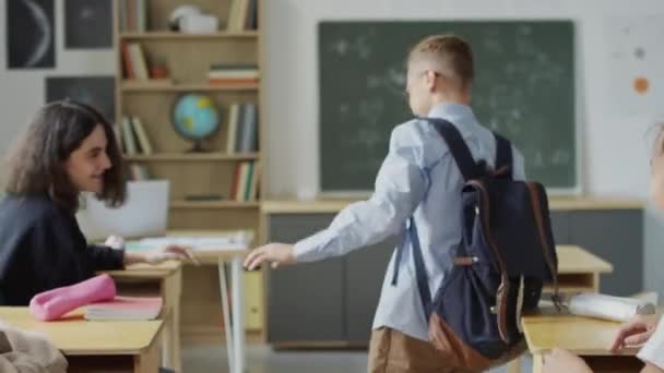 Selective Focus Shot Teen Boy Walking Aisle Desks Classroom His — Stock Video