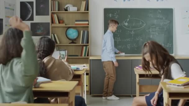 Selective Focus Shot Teenagers Sitting Desks Classroom Bullying Classmate Throwing — Stock Video