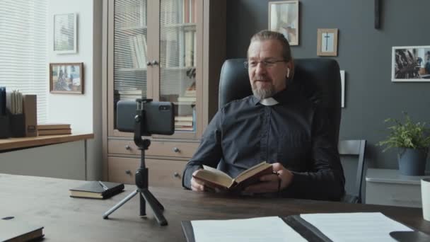 Portret Van Volwassen Kaukasische Katholieke Priester Zit Voor Smartphone Statief — Stockvideo