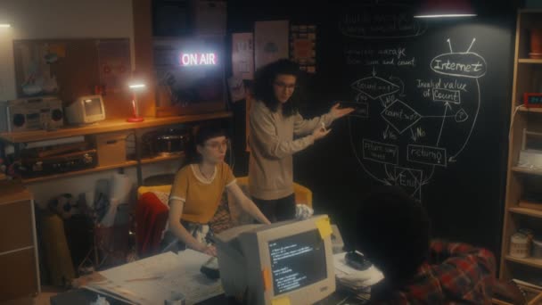 三个年轻的It专家小组在黑板上开发新的计算机系统 集思广益和绘图示意图 — 图库视频影像