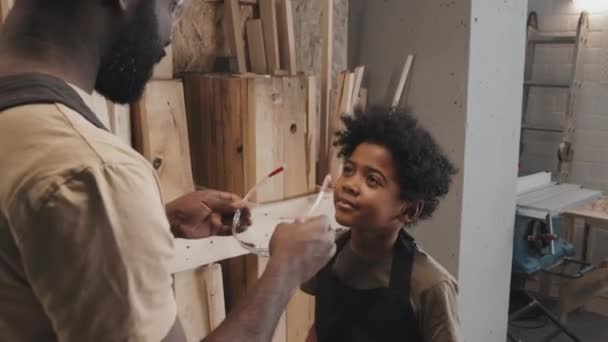 Tilt Shot Dad Putting Glasses Son Preparing Safe Crafting Carpentry — Stock Video