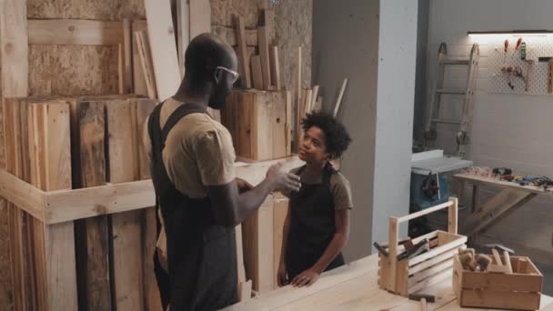 African American Father Apron Instructing Son How Work Carpentry Workshop — Stock Video