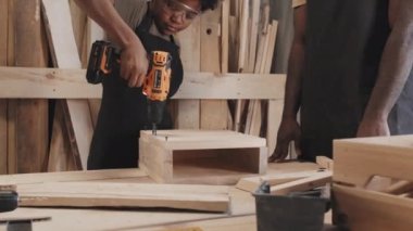 Afro-Amerikan uzmanının marangozluk atölyesinde çocuk işçiliği çekimini kaldır, çak bir beşlik