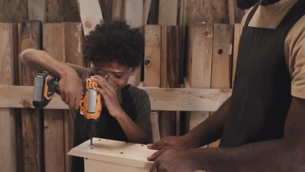 Medium Shot African American Son Drilling Screw Roof Birdhouse While — Stock Video