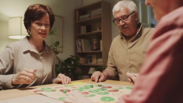 Přes Rameno Starších Lidí Pomocí Kostky Při Hraní Deskové Hry — Stock video