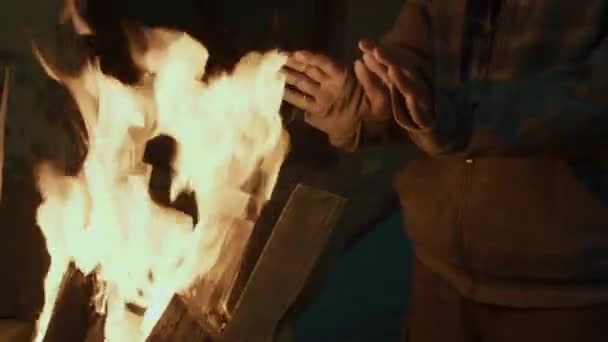 Średnie Zbliżenie Rąk Zamarzniętego Mężczyzny Rozgrzewającego Się Pobliżu Lufy Ognia — Wideo stockowe