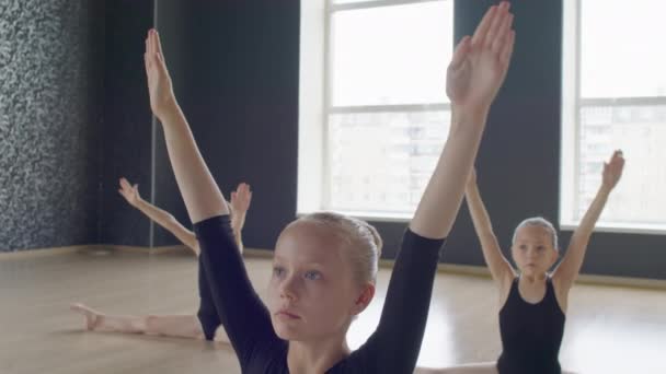 Group Little Ballerinas Doing Downward Circular Motion Arms While Sitting — Stock Video