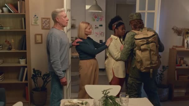Medium Long Shot Intercultural Family Hugging Man Uniform Leaving Military — Stock Video