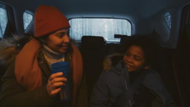 在冬天开车去某个地方时 与穿着保暖衣服的男孩交谈的中档女人的照片 — 图库视频影像