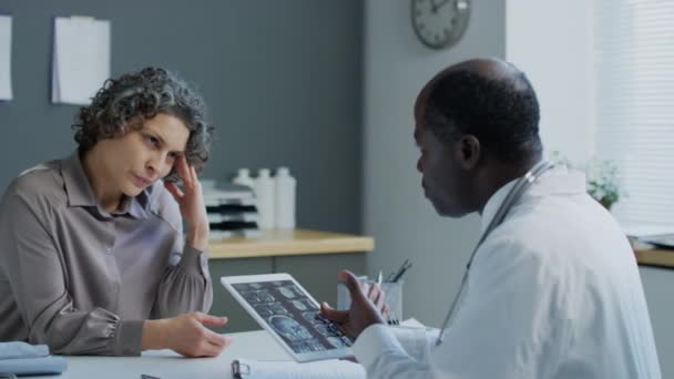 아프리카계 미국인 의사에게 편두통에 머리를 코카서스 여성의 병원에서 태블릿에 Mri — 비디오