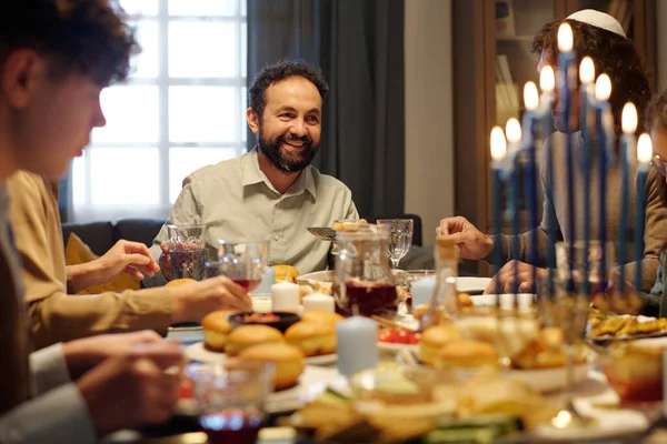 Cheerful Mature Man Looking One Guests Hanukkah Dinner His Family — Stock Photo, Image