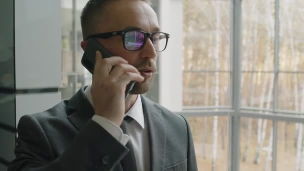 Brustbild Eines Geschäftsmannes Mit Brille Und Grauem Anzug Der Telefon — Stockvideo
