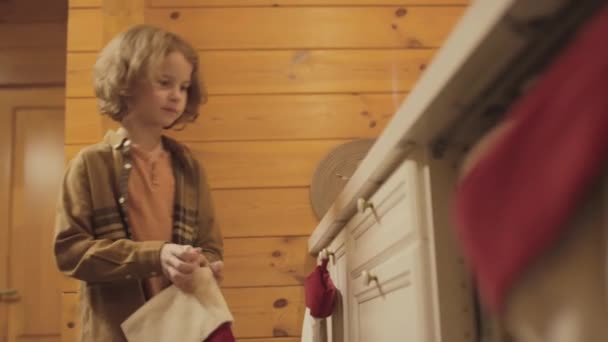 Medium Shot Boy Curly Hair Hanging Christmas Stocking Hook Kitchen — Stock Video