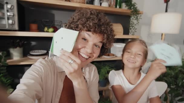 Handheld Slow Motion Shot Modern Mother Preteen Daughter Holding Paper — Stock Video