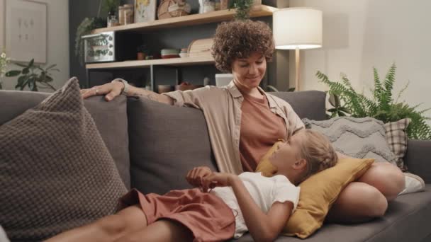 Moderní Běloška Kudrnatými Vlasy Dcerou Odpočívající Pohovce Obývacím Pokoji Doma — Stock video