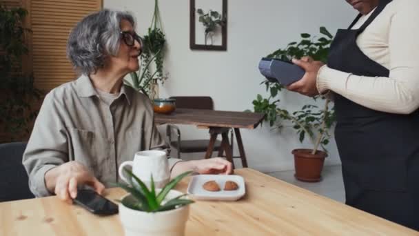 Starší Žena Šedými Vlasy Platí Její Objednávku Kavárně Pomocí Chytrého — Stock video
