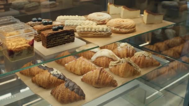 Assorted Sweet Baked Goods Display Shelves Bakery Croissants Eclairs Cakes — Stock Video