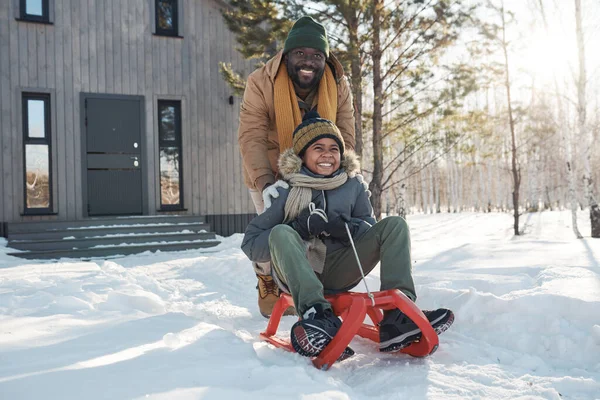 Happy Young African American Man Warm Winterwear Pushing Sledge His — Stock Photo, Image