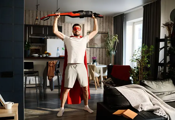 Young Superman Red Mantle Mask Holding Vacuum Cleaner His Head — Stock Photo, Image