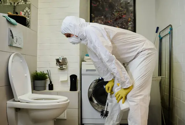 Young Man Protective Workwear Bending Ceramic Toilet Bowl Flushing While — Stock Photo, Image