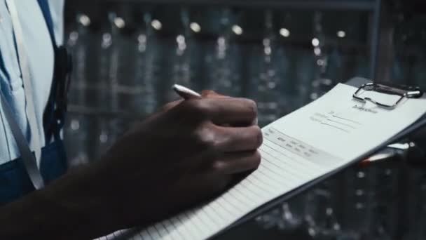 Tilt Side Closeup African American Male Inspector Filling Out Delivery — Stock Video