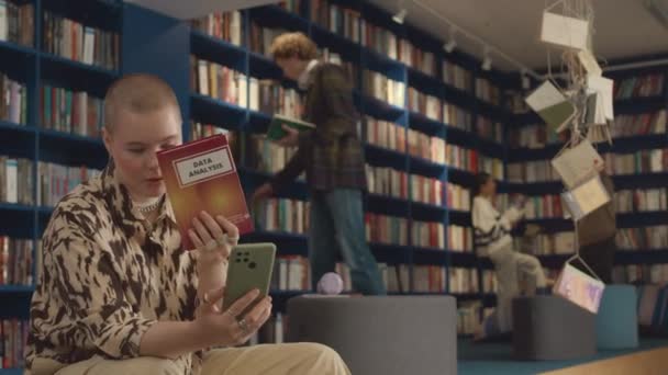 도서관에 머리를 코카서스 여성의 스마트 친구와 그리고 그녀가 읽기로 선택한 — 비디오
