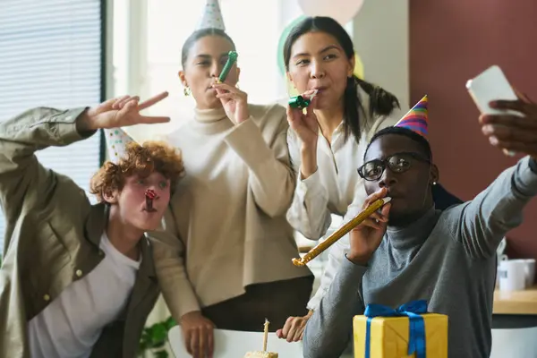 Young Cheerful Office Workers Birthday Caps Whistling Noisemakers Looking Camera — Stock Photo, Image