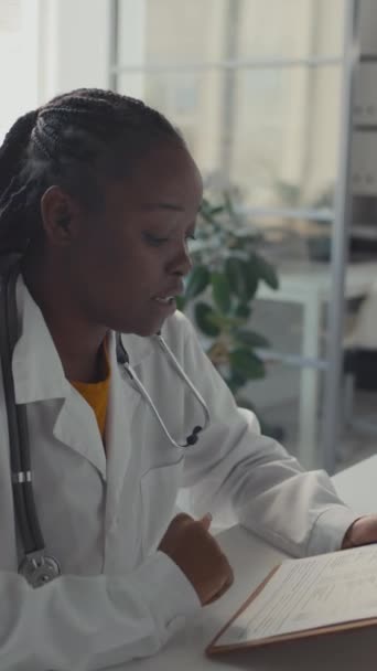 Medium Vertical Shot Attentive Young African American Female Physician Sitting — Stock Video
