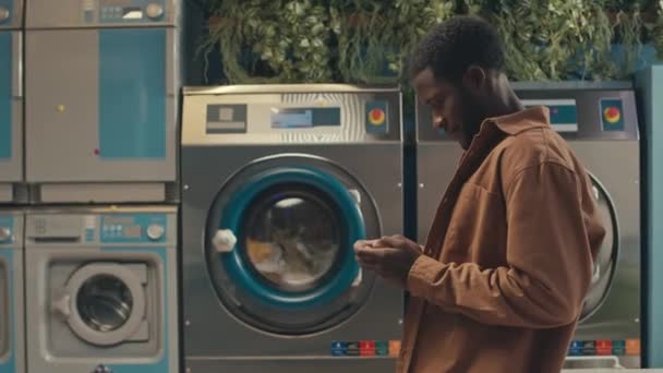 Side Footage Young Black Man Waiting Washing Machine Stop Washing — Stock Video