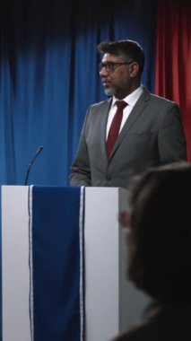 Başkan, Senato, Kongre ya da valinin seçim tartışmalarına katılıp rakip gündemi eleştirdiği, halkın sorularını yanıtladığı olgun Hintli Amerikalı politikacının tam dikey çekimi