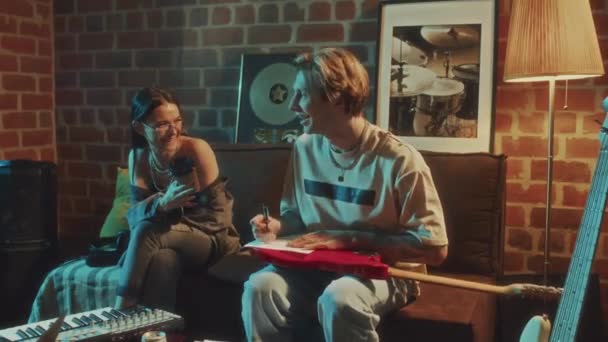 코카서스 여성과 남자가 레트로 스튜디오에서 앨범을위한 새로운 노래를 논의하고 저녁에 — 비디오