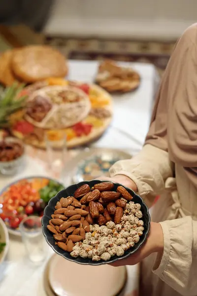 Closeup Hands Unrecognizable Muslim Woman Holding Plate Full Sweet Almond Royalty Free Stock Photos