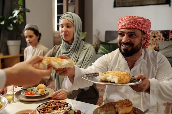 Selective Focus Shot Cheerful Muslim Man Sitting Table Sharing Flatbread Stock Image