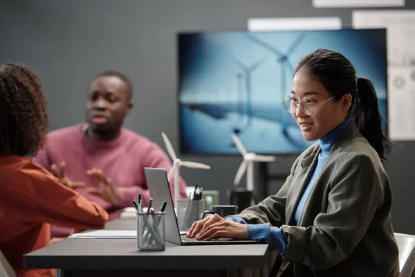 Young Smiling Businesswoman Formalwear Sitting Desk Windmill Models Networking Colleagues Stock Photo