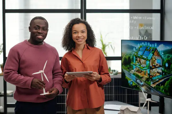 Two Happy Young African American Employees Tablet Windmill Model Looking Royalty Free Stock Images