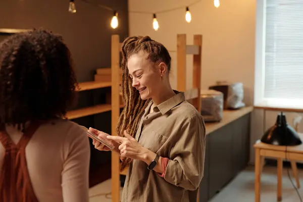 Happy Young Female Entrepreneur Pointing Tablet Screen Presentation Project Points Stock Picture