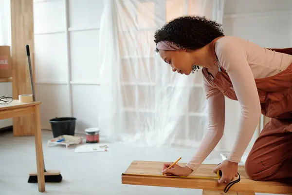 Side View Young Female Worker Cafe Overalls Bending Wooden Bench Stock Picture
