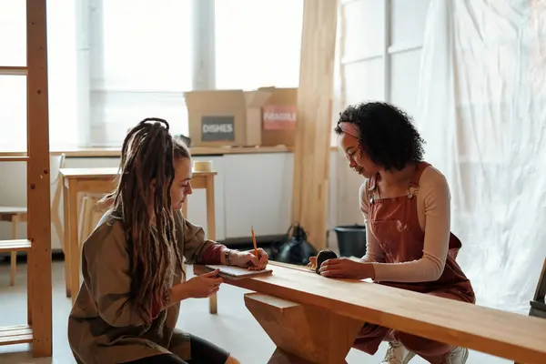 Young Businesswoman Dreadlocks Making Notes Copybook While Her Colleague Measuring Stock Picture