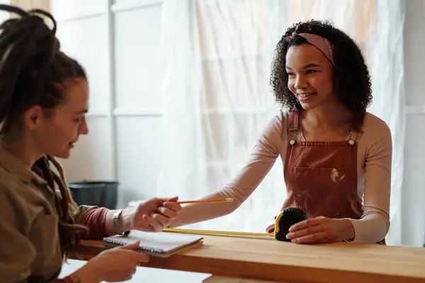 Young Smiling Female Worker Designer Overalls Taking Measures Bench Looking Royalty Free Stock Photos
