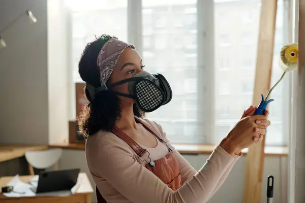 Young African American Female Worker Overalls Protective Respirator Holding Handle Stock Photo