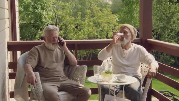 Střední Záběr Dvou Starších Bělochů Sedících Spolu Křeslech Stolu Terase — Stock video
