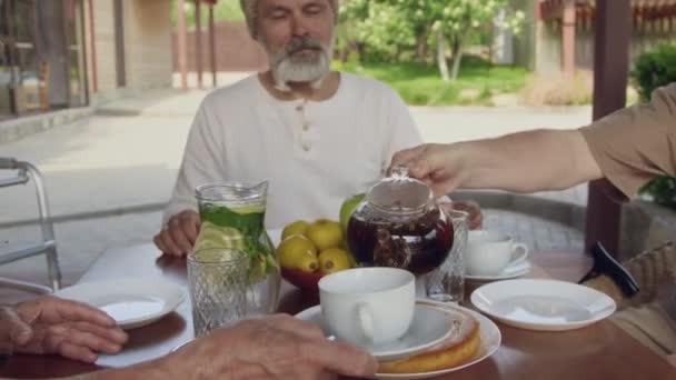 Közepes Közelkép Idős Férfi Kezéről Amint Teát Töltenek Egymásnak Miközben — Stock videók
