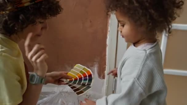 Side Handheld Footage Caucasian Mother Biracial Daughter Choosing Wall Color — Stock Video