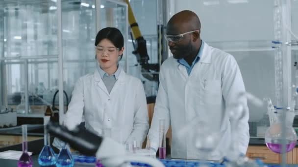 Средние Кадры Афроамериканских Мужчин Китайских Женщин Химиков Стоящих Столешницей Переполненной — стоковое видео