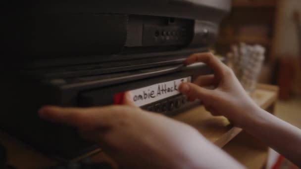 Close Hands Mischievous Gen Kid Putting Cassette Zombie Attack Film — Αρχείο Βίντεο