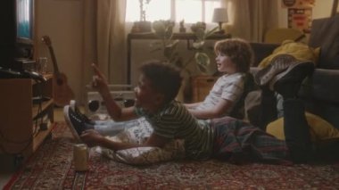 Ekranda çeşitli arkadaşların TV 'de film izlediği ve okuldan sonra nostaljik 90' lı yılların oturma odasında takılırken eğlendiği el kamerası görüntüleri var.