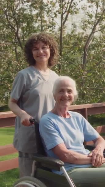 Medium Vertical Portrait Shot Young Female Nurse Posing Elderly Caucasian — Stock Video