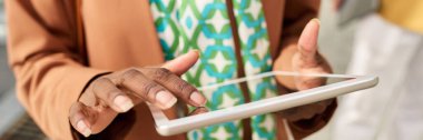 Close-up of person using tablet for work or study, showing hands interacting with touch screen and blurry background, emphasizing digital interaction without showing full face clipart